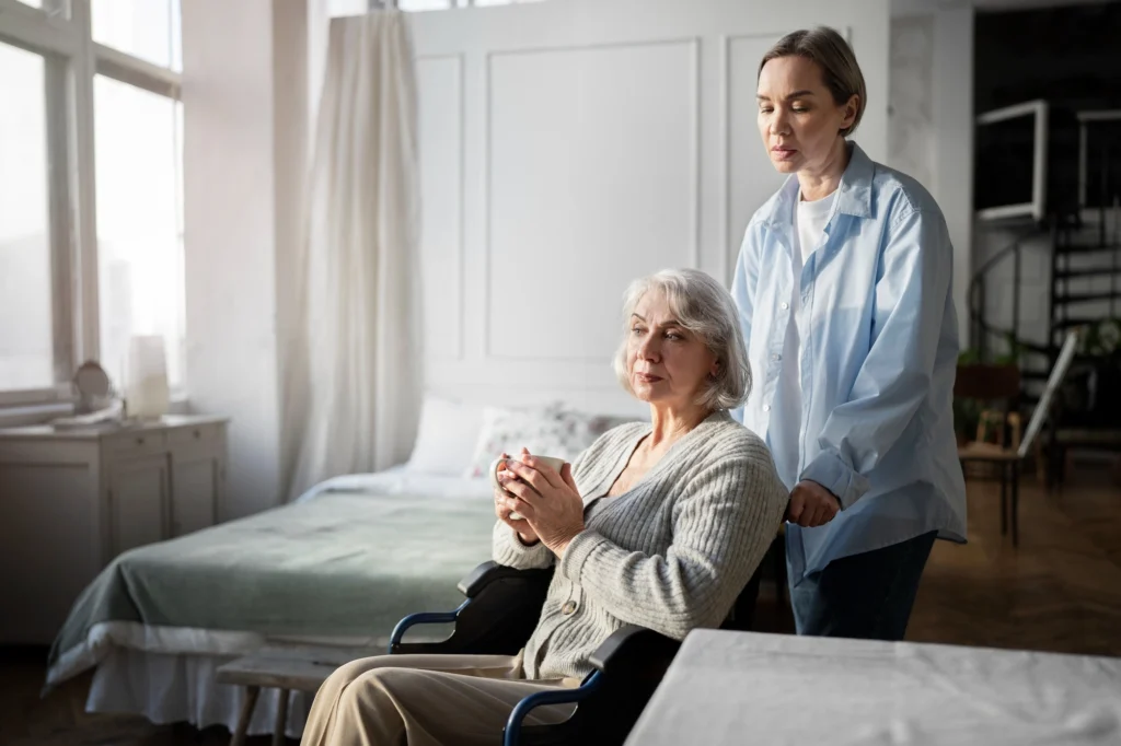 Caregiver smiling and talking with an elderly man at home, offering companionship and support.