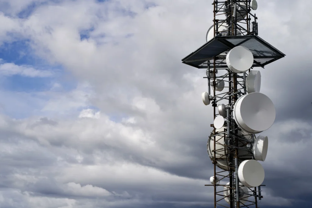 Technician climbing a telecom tower for maintenance work — Shifton Field Service