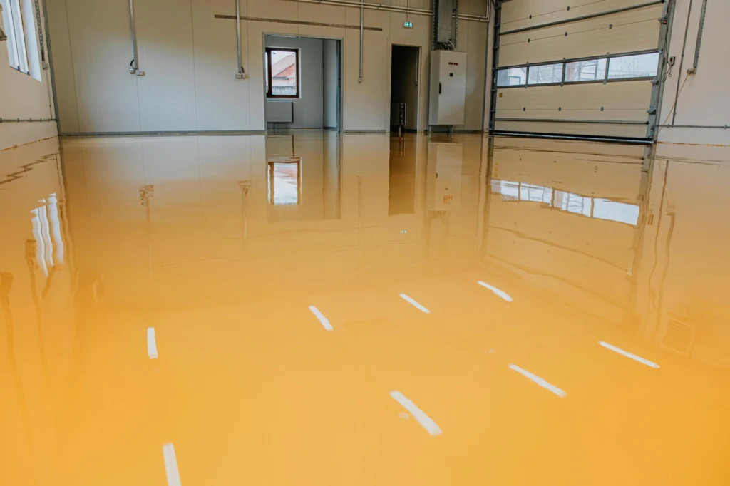 Technician applying epoxy sealant to a crack in a concrete floor at an industrial site — Shifton Field Service