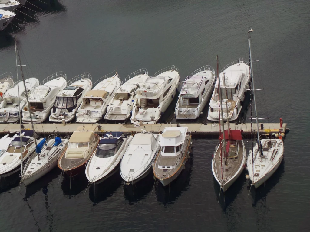 Marine technician performing maintenance and inspection on boats at the marina — field service operations
