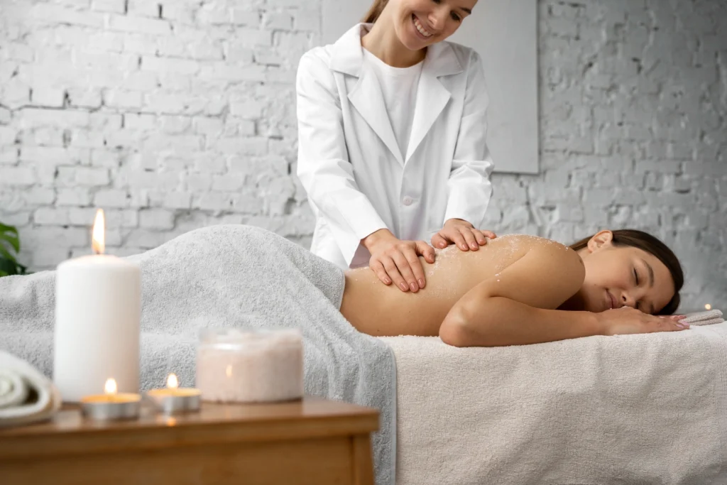 Massage therapist giving a relaxing back massage to a client in a spa setting