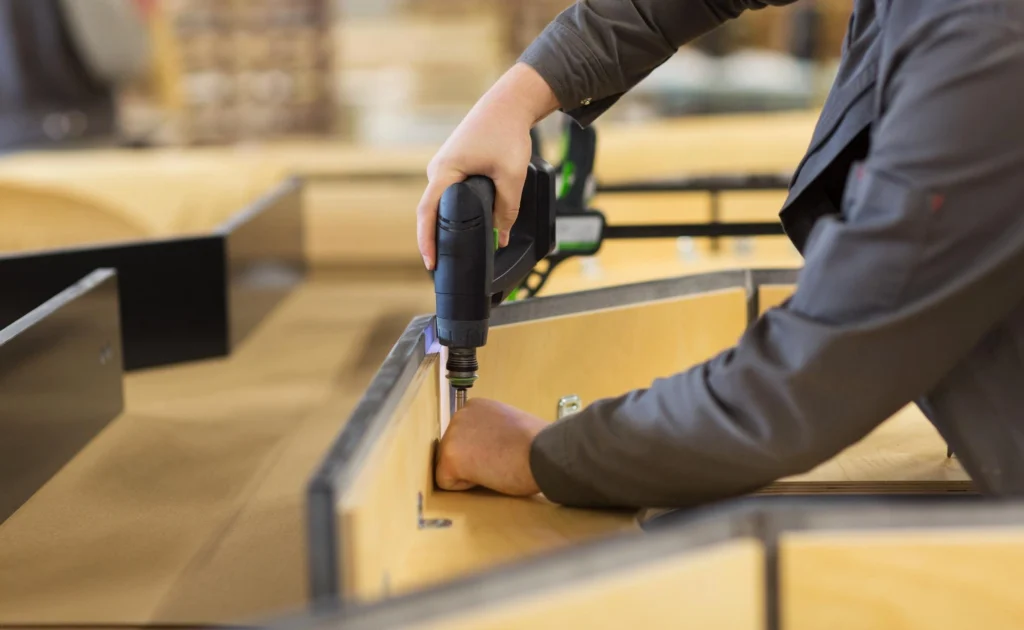 Technicians assembling office furniture on-site in a modern workspace — Shifton Field Service