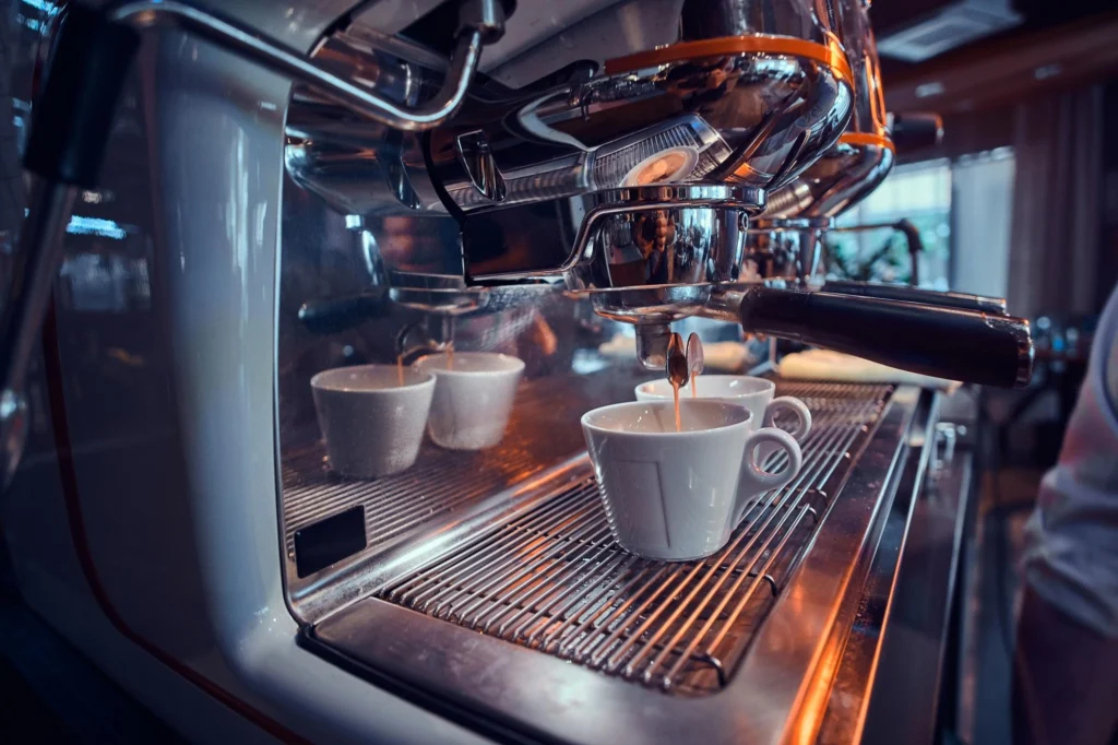 Technician performing commercial coffee machine maintenance — field service management setup