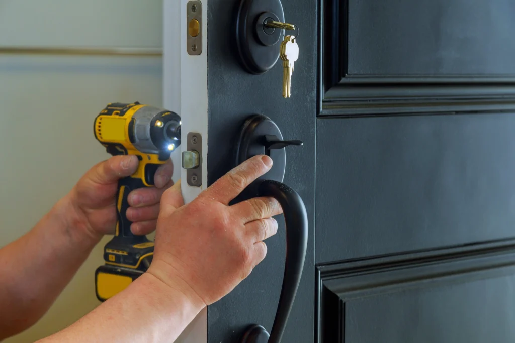 Professional locksmith providing door lock repair and installation — field service technician